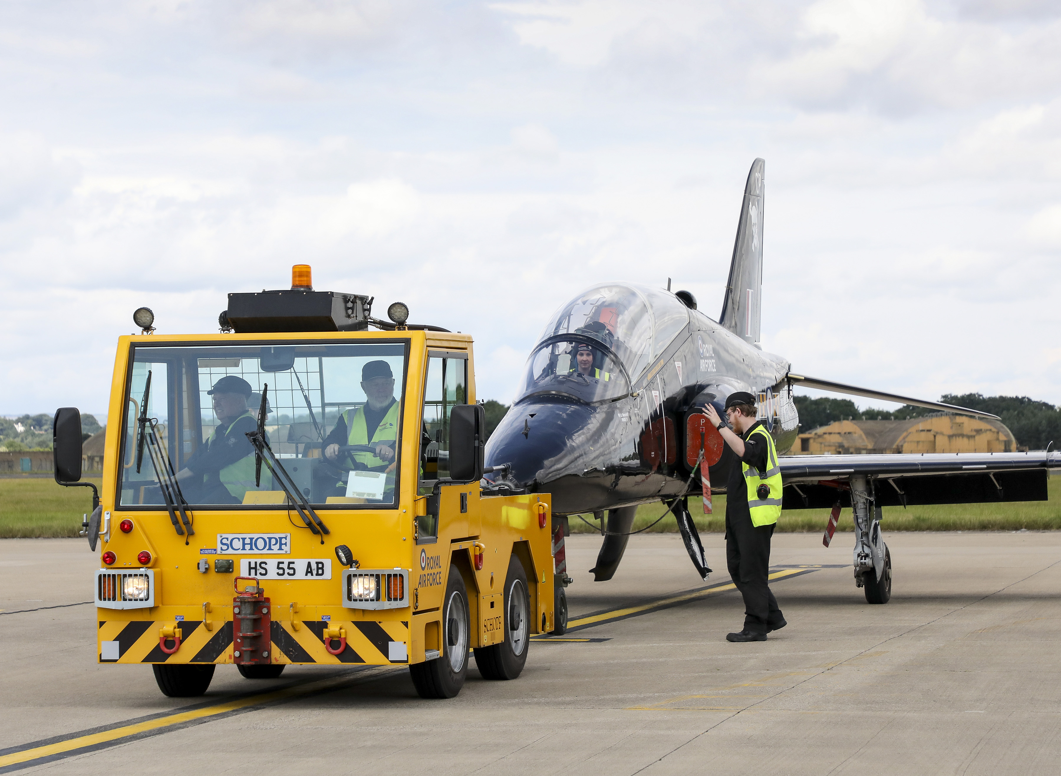 Image shows a Towing Tractor vehicle towing a Hawk T2 aircraft on the airfield.